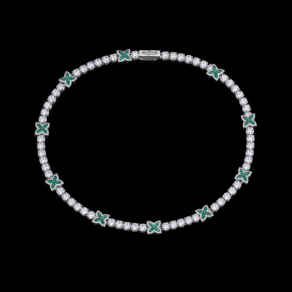 Petey's jewelry silver-plated tennis chain featuring round white zircon stones and green four-leaf clover accents.