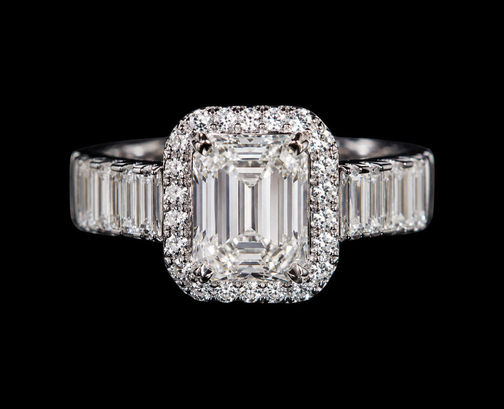 Petey's jewelry emerald-cut moissanite engagement ring with a halo of small diamonds and baguette side stones, set in silver.