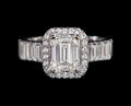 Petey's jewelry emerald-cut moissanite engagement ring with a halo of small diamonds and baguette side stones, set in silver.