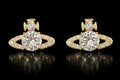 Petey's jewelry gold-tone planet stud earrings with VVS moissanite stones and cross detail on a black background.