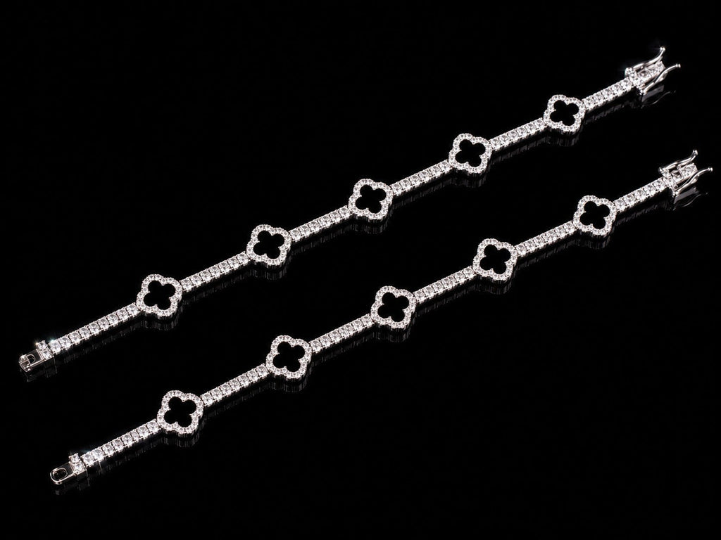 Petey's jewelry 925 sterling silver clover tennis bracelet with iced out VVS moissanite diamonds on a black background