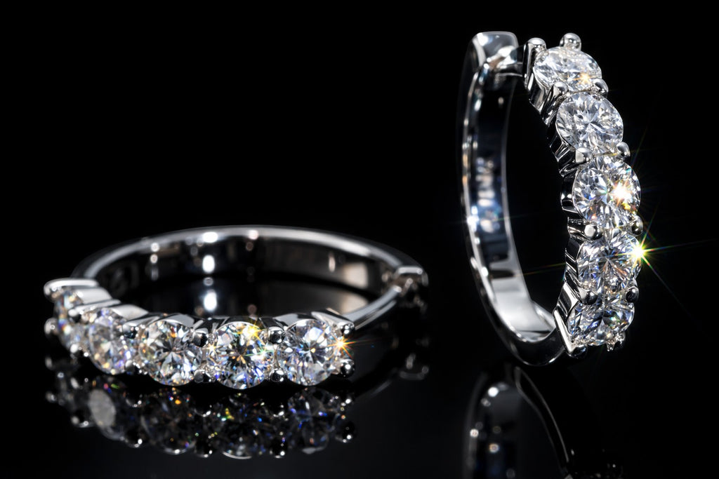 Petey's jewelry sterling silver huggie hoop earrings featuring sparkling round brilliant cut moissanite stones.