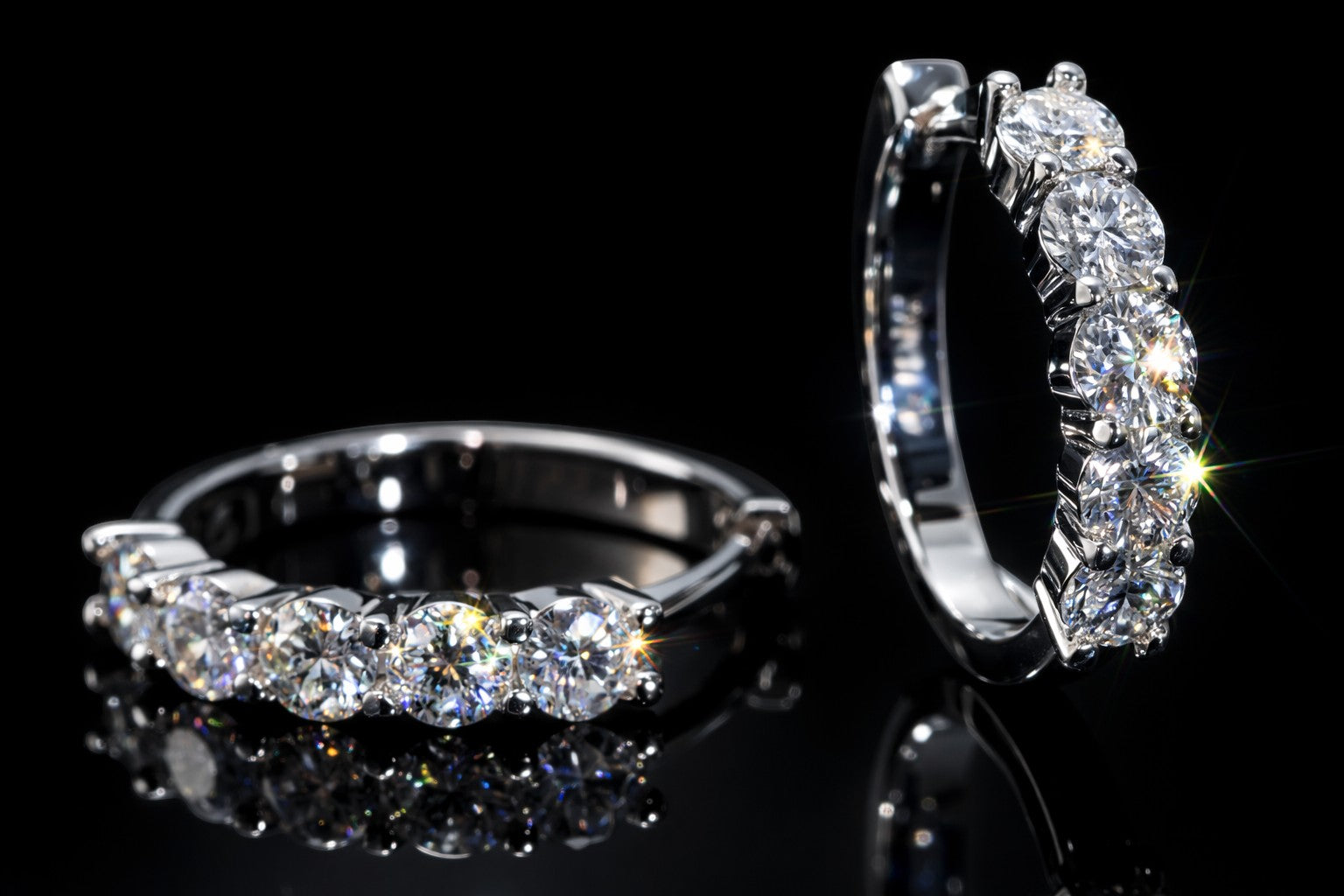 Petey's jewelry sterling silver huggie hoop earrings featuring sparkling round brilliant cut moissanite stones.
