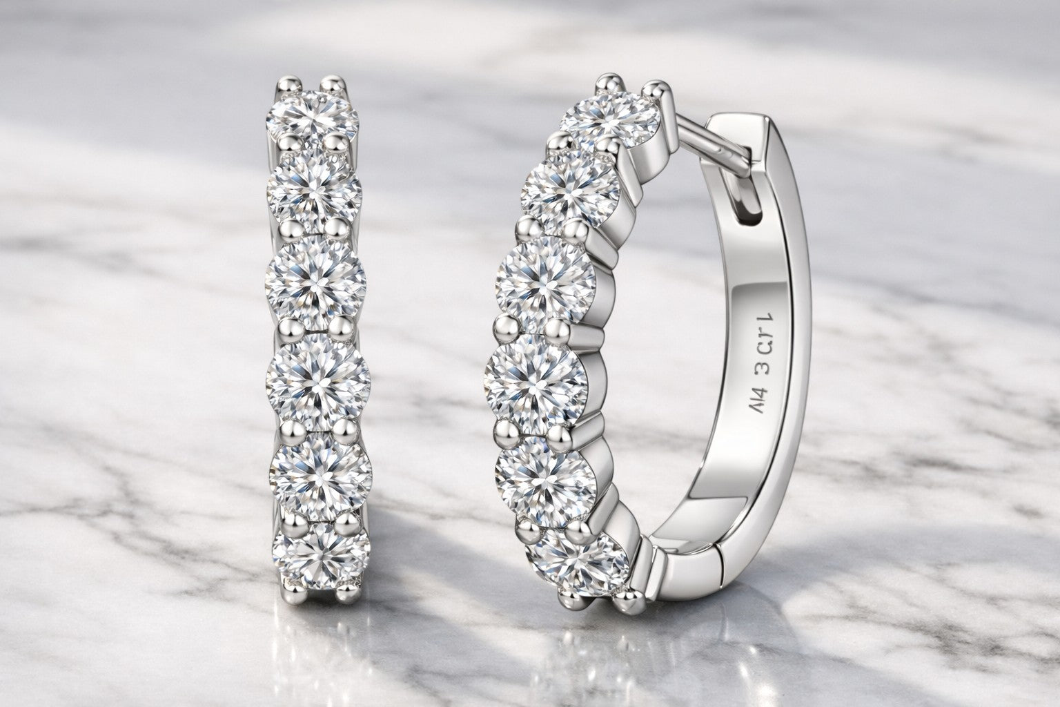Petey's jewelry huggie hoop earrings featuring round brilliant cut moissanite stones in 14K gold plated sterling silver.