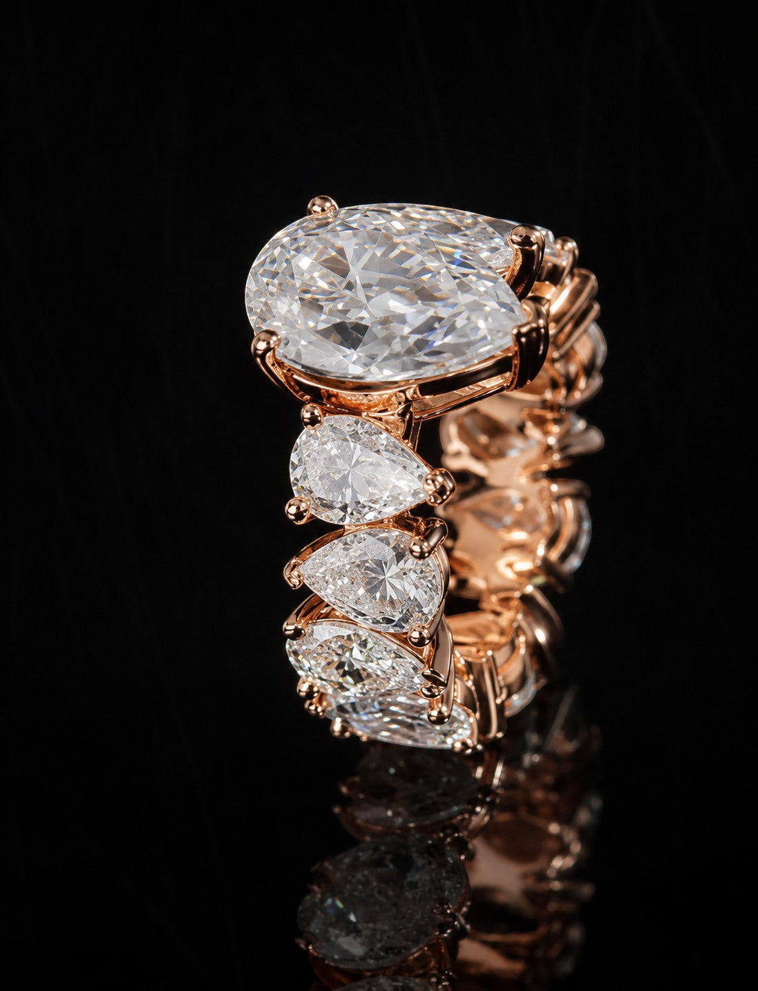Petey's jewelry rose gold ring with multiple pear-cut VVS moissanite stones in a full eternity band style.