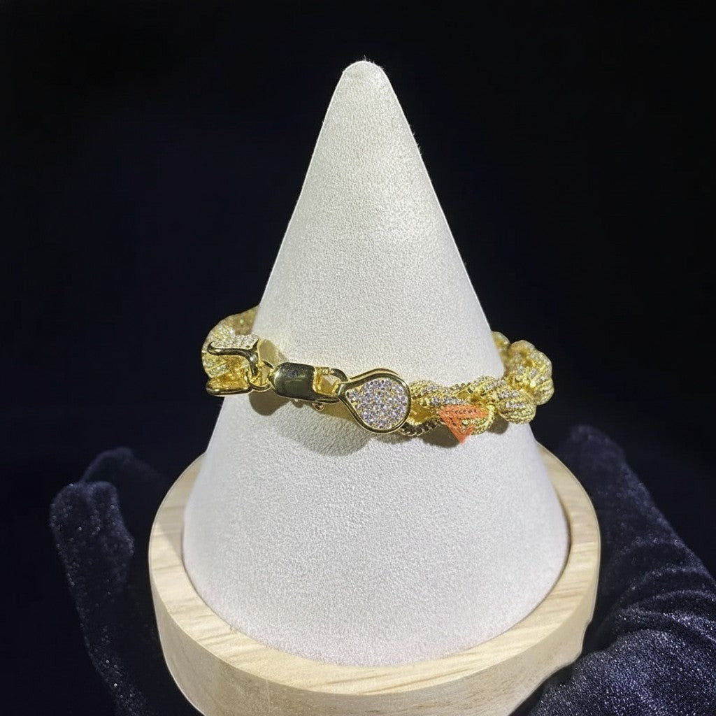 Petey's jewelry iced out gold-plated sterling silver rope chain bracelet with VVS moissanite stones on a display