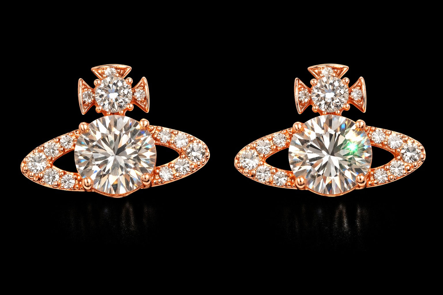 Petey's jewelry rose gold planet stud earrings with VVS moissanite stones and a cross detail on a black background.