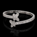 Petey's jewelry 925 sterling silver hip hop bangle featuring emerald cut VVS moissanite stones in a butterfly design.