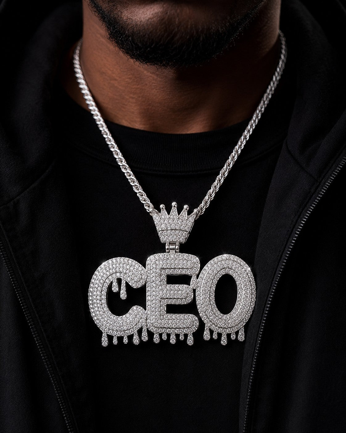 Petey's jewelry iced out CEO letter pendant with moissanite diamonds on a silver chain worn by a man in a black hoodie
