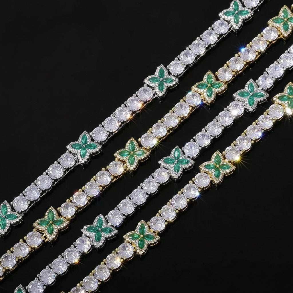 Petey's jewelry iced out tennis chain featuring green zircon four-leaf clover accents and clear round brilliant stones.