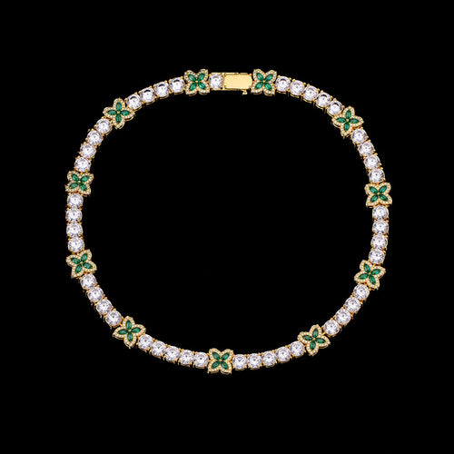 Petey's jewelry iced out tennis chain featuring alternating clear round and green four-leaf clover zircon stones.