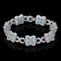 Petey's jewelry iced out clover bracelet in 925 sterling silver with VVS blue moissanite stones on a black background