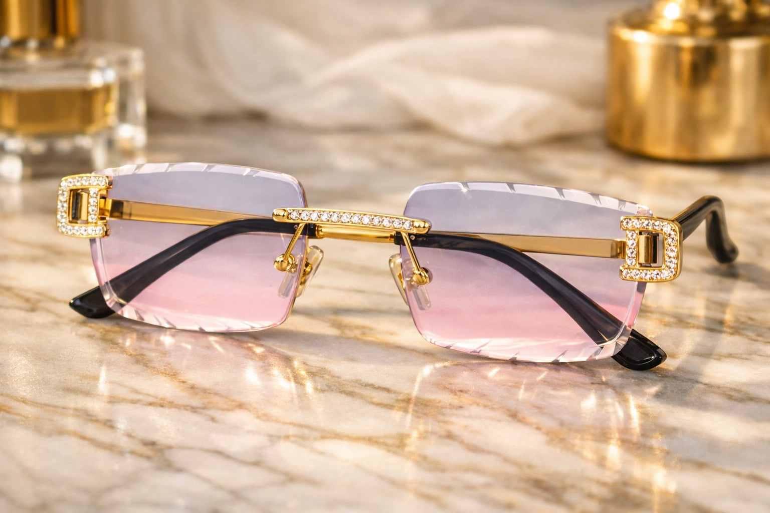 Petey's jewelry iced out designer glasses with pink and gray gradient lenses, gold frames, and diamond-cut detailing.