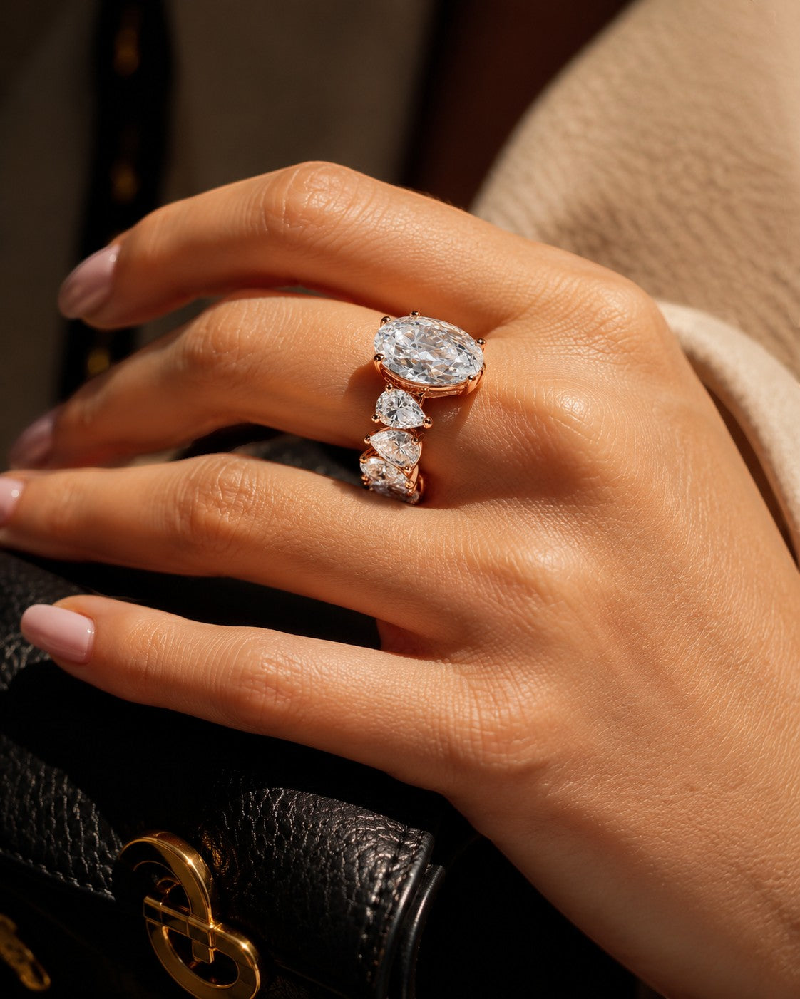 Petey's jewelry rose gold ring with oval and pear-cut VVS moissanite stones. Engagement ring.