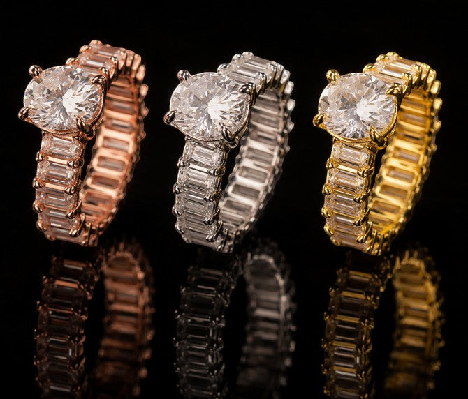 Petey's jewelry three iced out moissanite rings in rose gold, silver, and gold, featuring baguette and round cut stones.