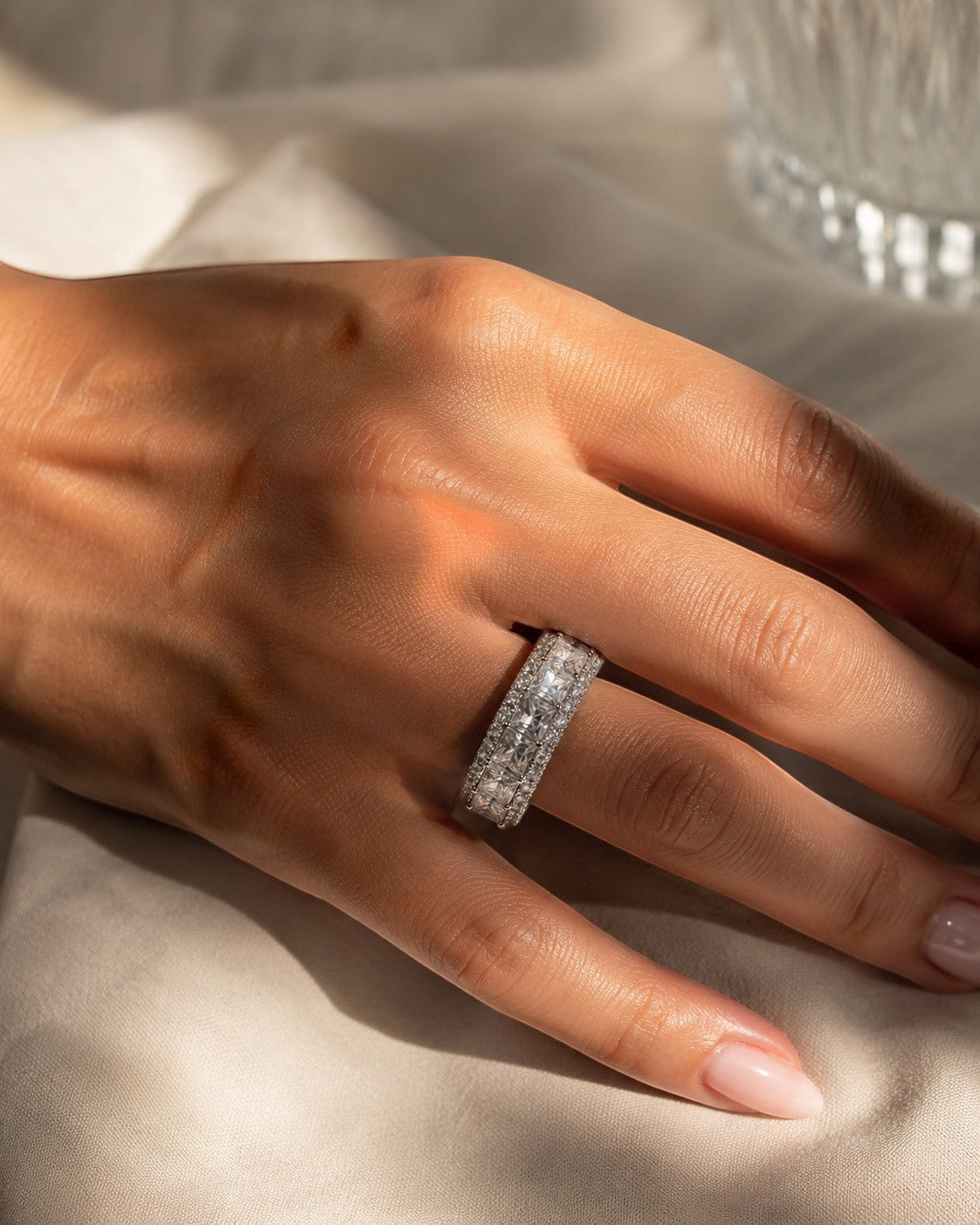 Petey's jewelry women's sterling silver ring with channel-set princess and round moissanite stones. Full diamond band.