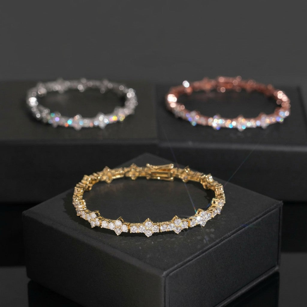 Petey's jewelry 925 sterling silver moissanite tennis chains in gold, silver, and rose gold finishes on display boxes.
