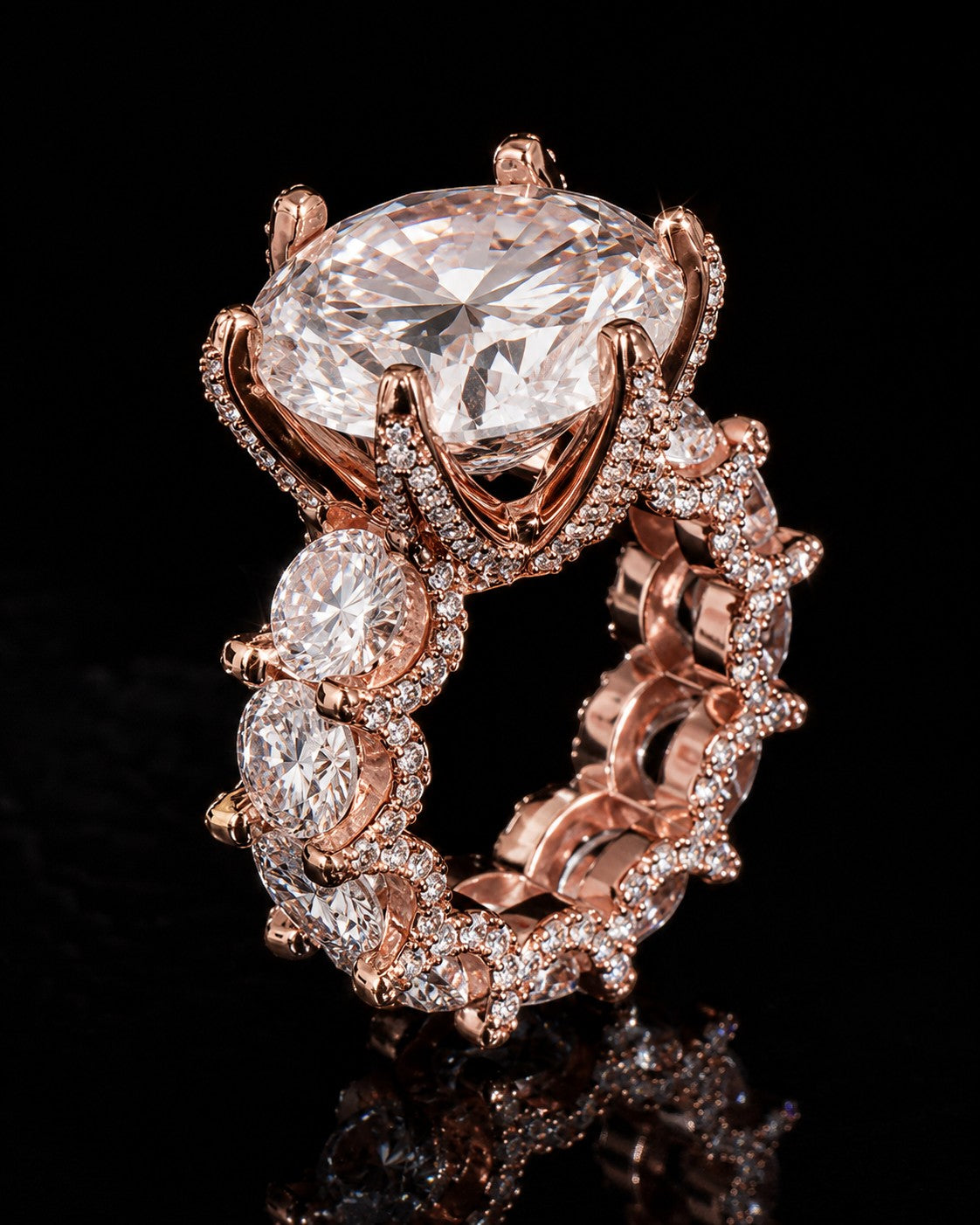 Petey's jewelry rose gold ring with large center moissanite and pavé-set stones on band.