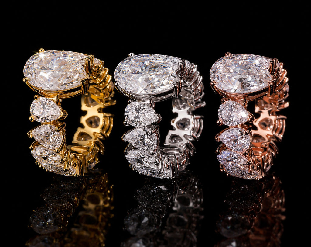 Petey's jewelry three luxury moissanite rings in gold, silver, and rose gold, featuring large pear-cut center stones and smaller pear-cut accent stones.